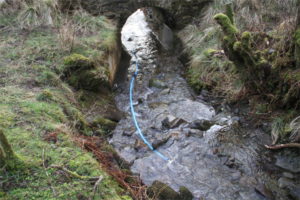 Recent rainfall has caused the stream level to rise and cover manifold